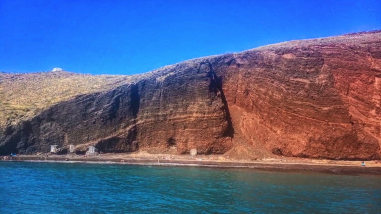 Cliffs overlooking the ocean with vibrant blue sky and calm waters, showcasing natural beauty and ge.