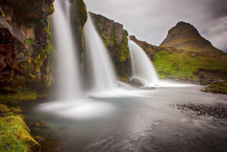 Beautiful Iceland waterfall with cascading streams and lush green surroundings.